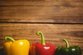 Multi colored bell peppers on chopping board Royalty Free Stock Photo