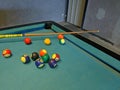 Multi-colored billiard balls on a pool table Royalty Free Stock Photo