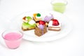 Multi-colored biscuit cakes on a white plate with berry mousse in glasses. Celebration, breakfast, baby food. Top view at an angle Royalty Free Stock Photo