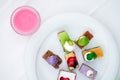 Multi-colored biscuit cakes on a white plate with berry mousse in glasses. Celebration, breakfast, baby food. Top view Royalty Free Stock Photo