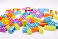 Multi colored blocks of a children designer scattered on a white background