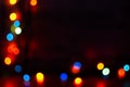 Multi-colored bokeh on a black background. Bright blurry textures of holiday lights Royalty Free Stock Photo