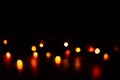 Multi-colored bokeh on a black background. Bright blurry textures of holiday lights Royalty Free Stock Photo