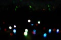 Multi-colored bokeh on a black background. Bright blurry textures of holiday lights Royalty Free Stock Photo