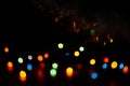Multi-colored bokeh on a black background. Bright blurry textures of holiday lights Royalty Free Stock Photo