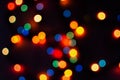 Multi-colored bokeh on a black background. Bright blurry textures of holiday lights Royalty Free Stock Photo