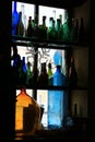 Multi-colored bottles are on windowsill Royalty Free Stock Photo