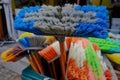 Multi-colored bright brushes, mops for manual cleaning of premises from dust and dirt. Artificial pile  plastic handles Royalty Free Stock Photo