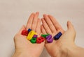 Multi-colored bright children`s numbers for development from zero to nine lie in a handful in both palms of the hand Royalty Free Stock Photo