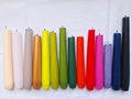 Multi-colored burnt candles stand in a row. Royalty Free Stock Photo