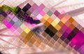 Multi-colored cells in warm shades are located diagonally against a blurred pink background.