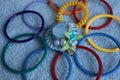 Multi-colored children`s bracelets and hairpin in the form of a blue hat.
