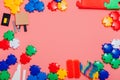 Multi-colored children`s development games designer toys on a pink background