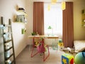 A multi-colored children`s room with desk, a variety of designer toys and decor. Green, light green, brown, white Royalty Free Stock Photo