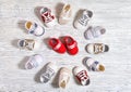 multi-colored children`s shoes on a white-gray non-uniform wooden background Royalty Free Stock Photo