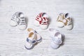 Multi-colored children`s shoes on a white-gray non-uniform wooden background Royalty Free Stock Photo