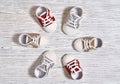 Multi-colored children`s shoes on a white-gray non-uniform wooden background close-up Royalty Free Stock Photo