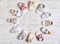 Multi-colored children`s shoes on a white-gray non-uniform wooden background close-up Royalty Free Stock Photo