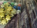 Multi-colored Christmas balls and stars in a packing box on a wooden table.  Close-up Royalty Free Stock Photo