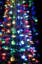 a multi - colored christmas tree with lights on it Royalty Free Stock Photo