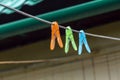 Multi-colored clips for washing laundry clothespin on strip rope outdoor Royalty Free Stock Photo