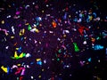 Multi-colored confetti from a Christmas cracker lies on the ground Royalty Free Stock Photo