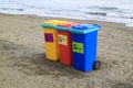 multi-colored containers for sorting garbage are on the beach ag Royalty Free Stock Photo