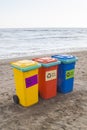 multi-colored containers for sorting garbage are on the beach ag Royalty Free Stock Photo