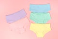 Multi-colored cotton panties for a girl on a pink background Royalty Free Stock Photo