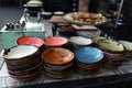 Multi-colored country-style faience plates for snacks, prepared for table setting