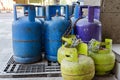 Multi-colored and different-sized gas cylinders on the street. Bottles with liquefied petroleum gas LPG