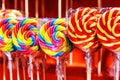 Multi-colored disc shaped lollipops. Caramel on a stick in the store. Sweet trade for children