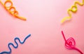 Multi-colored drinking straws on a pink background. Twisted tubules for drinks in different colors. Holiday. Celebration