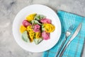 Multi colored dumplings from color dough stuffed with meat on concrete background