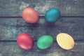 Multi-colored eggs painted with gouache and onion peel close up on wooden background. Five boiled eggs. Postcard poster