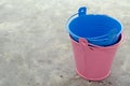 Multi-colored empty mini buckets on gray background. Aluminum bucket for flower garden for the manufacture of accessories for the Royalty Free Stock Photo