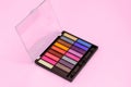 Multi-colored eye shadow palette. Bright colors and shades in cosmetics. Minimalism cosmetic concept.