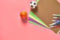 Multi colored felt pens, paper sheets and toy balls lies on pink desk in kindergarten Royalty Free Stock Photo