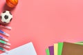 Multi colored felt pens, white blank paper sheet for drawing and toy balls lies on pink desk in kindergarten