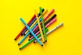 Multi-colored felt-tip pens on yellow background. Top view,business, office supplies. School office supplies. Minimal style. Colo Royalty Free Stock Photo
