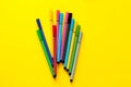 Multi-colored felt-tip pens on yellow background. Top view,business, office supplies. School office supplies. Minimal style. Colo Royalty Free Stock Photo