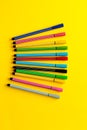 Multi-colored felt-tip pens on yellow background. Top view,business, office supplies. School office supplies. Minimal style. Colo Royalty Free Stock Photo