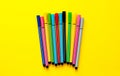 Multi-colored felt-tip pens on yellow background. Top view,business, office supplies. School office supplies. Minimal style. Colo Royalty Free Stock Photo