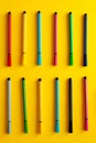 Multi-colored felt-tip pens on yellow background. Top view,business, office supplies. School office supplies. Minimal style. Colo Royalty Free Stock Photo