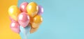 Multi-colored festive ballons on a yellow-blue background. Banner, copy space.