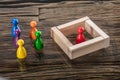 Multi Colored Figurine Pawn And Wooden Blocks On Desk