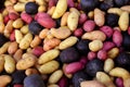 Multi-colored fingerling potatoes at an outdoor farmers' market.