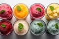 Multi-colored frozen ice drink made from juice. Sweet and very cold fruit lemonade. A variety with different cocktail flavors. Royalty Free Stock Photo