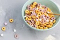 Multi colored fruit loops in a bowl with spoon Royalty Free Stock Photo