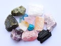 Multi-colored gemstones, raw minerals. Rose quartz, turquoise, citrine, aquamarines, fluorite, red gypsum, black tourmaline Royalty Free Stock Photo